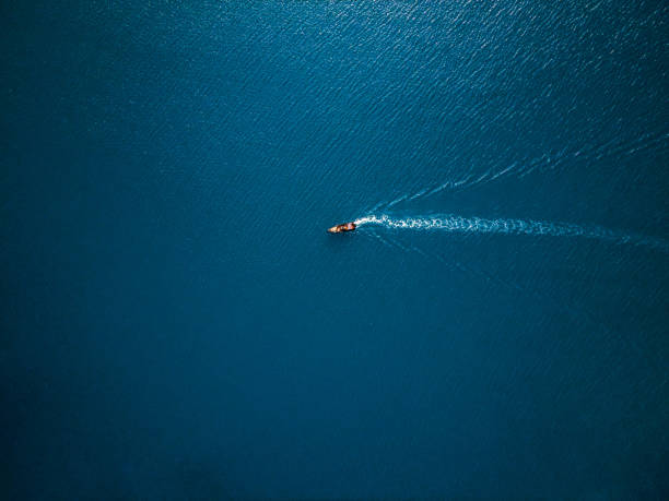 Aerial view of boat in the sea. Travel freedom concept. Shoot directly above stock photo
