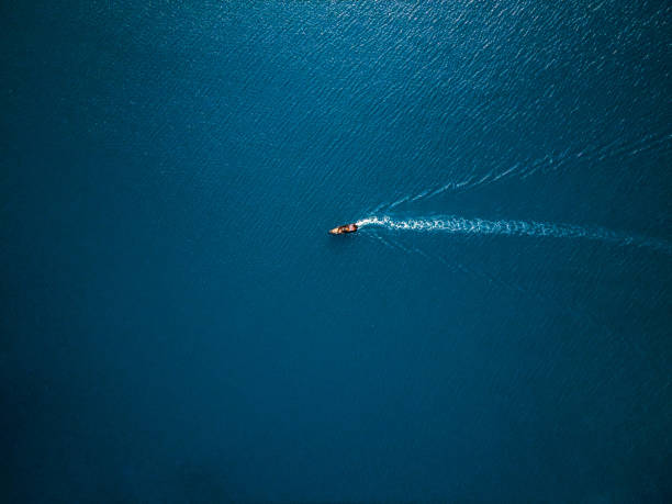 aerial view of boat in the sea. travel freedom concept. shoot directly above - sea water single object sailboat imagens e fotografias de stock