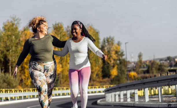 istock Two young plus size women jogging together. 1463500541