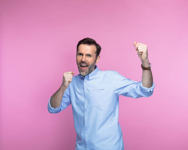 istock Happy man screaming with clenched fists 1463500613