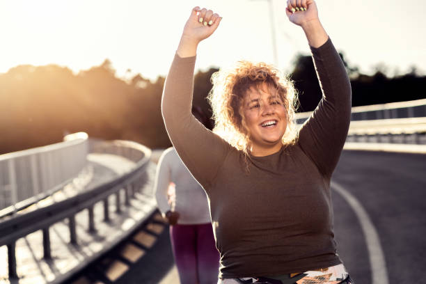 istock Two young plus size women jogging together. 1463500615