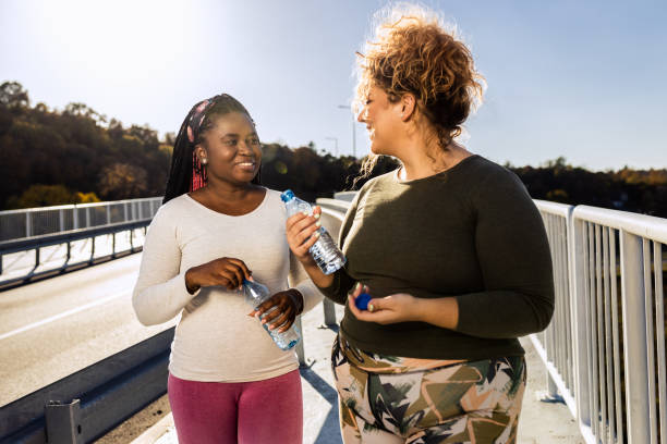 istock Two young plus size women relaxing after running. 1463500646
