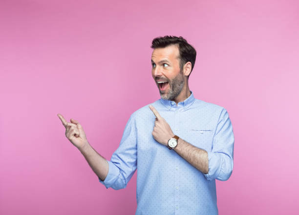 istock Happy mid adult man pointing 1463500658