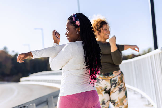 istock Two young plus size women stretching together before runnung. 1463500820