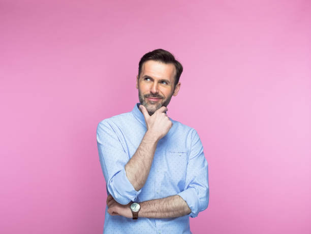 istock Man with hand on chin looking up 1463500895
