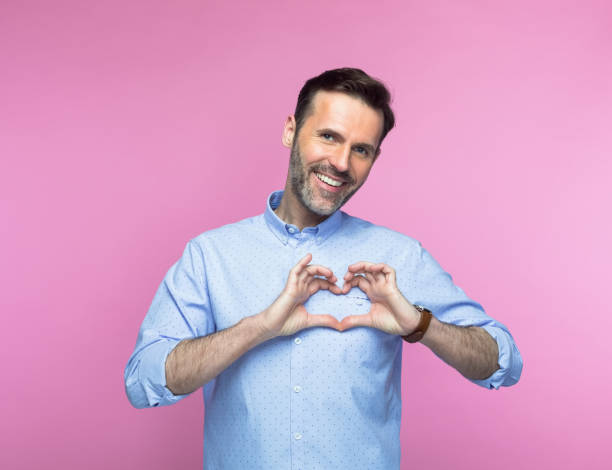 istock Smiling man gesturing heart sign 1463501611