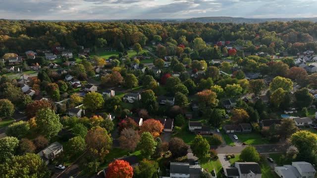 American town in autumn. Colorful fall foliage in residential suburban housing development. Homes in USA.