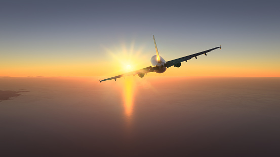 Commercial plane flying over the amazing sunset