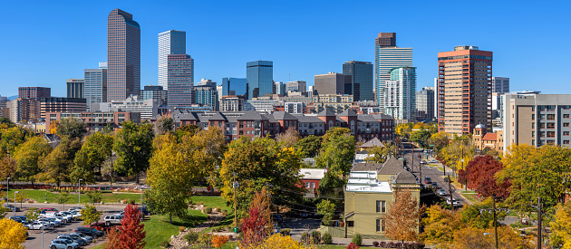 A panoramic view of Downtown Denver skyline on a sunny Autumn morning. Denver, Colorado, USA.