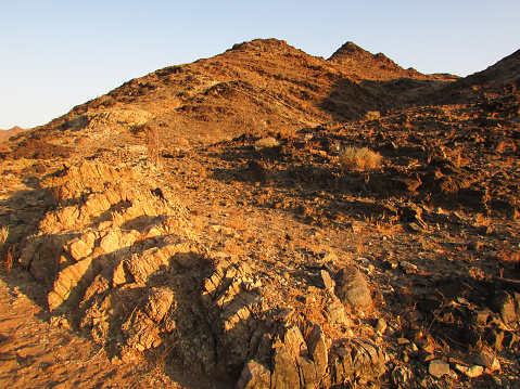 Outcroppings of Schist along the edge of the Fish River Canyon in Namibia in the early golden light.