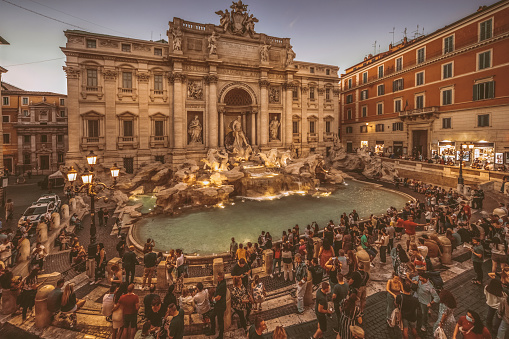 Couple contemplating the Trevi fountain in Rome, Italy\nPeople travel enjoying capital cities of Europe concept