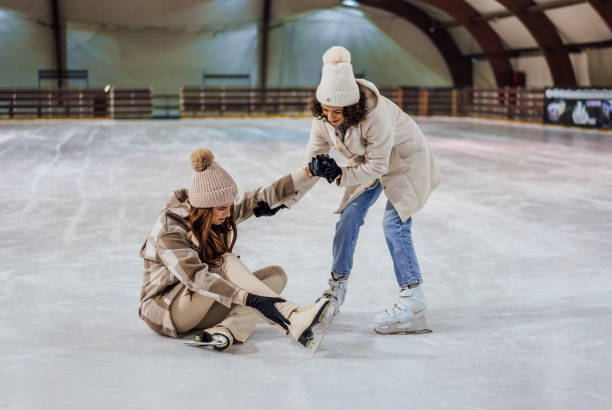 istock Woman helping her girlfriend who fell down to get up 1463509196