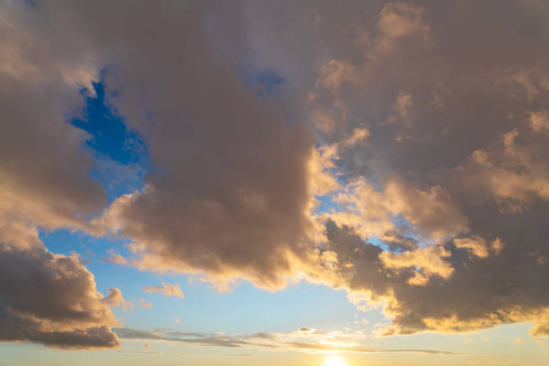 Beautiful orange bright sunset sky with dramatic clouds. Sunset sky background.