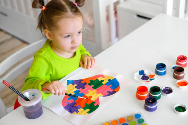 istock The child draws a picture with a thoughtful look looking ahead. 1463527193