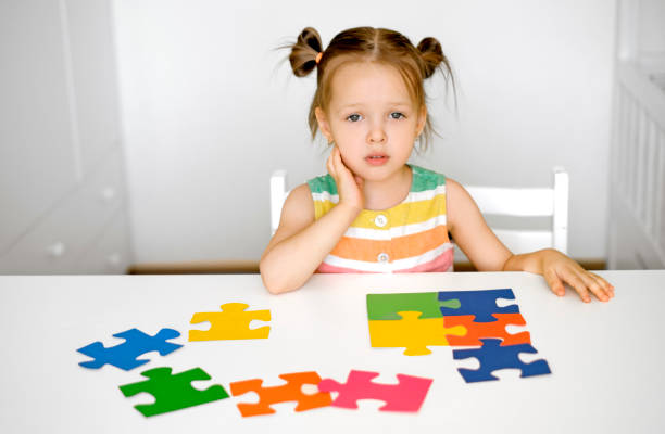 istock The child is sitting at table with sad look and looks at camera questioningly. 1463527489