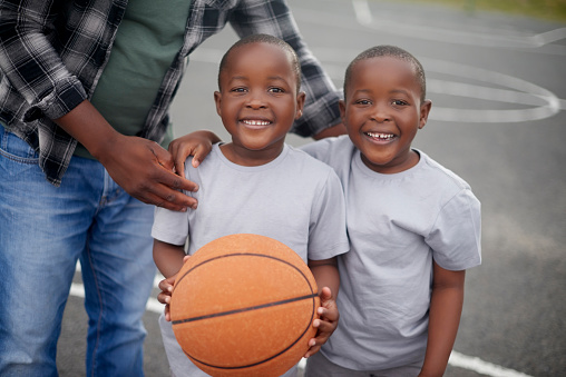 Happy, portrait and children with a black man for basketball training, motivation and sports inspiration. Fitness, smile and African boys excited to play a game of sport with a coach on a court
