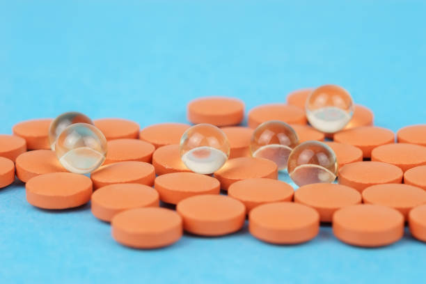 istock Assorted pharmaceutical medicine pills, tablets and capsules over blue background 1463529290