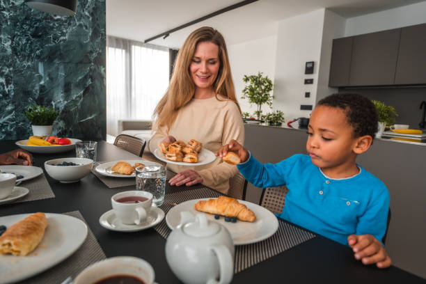istock Biracial Boy and Caucasian Mother Eating Breakfast 1463533419