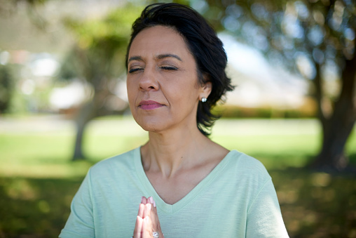 Yoga, meditation and senior woman in nature to pray, training mind and peace in New Zealand. Fitness, sport and an elderly person in a park for faith, spiritual exercise and workout to relax