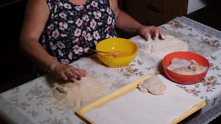 Fast motion of putting chicken legs into flour, egg mixture and bread crumbs