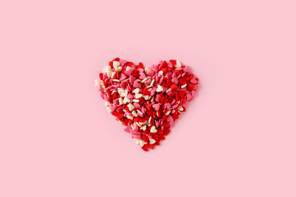 istock Heap sweets candies shape of heart on pink background 1463537232