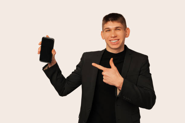 istock Look at this awesome offer on the phone screen says a smiling young man. 1463539497