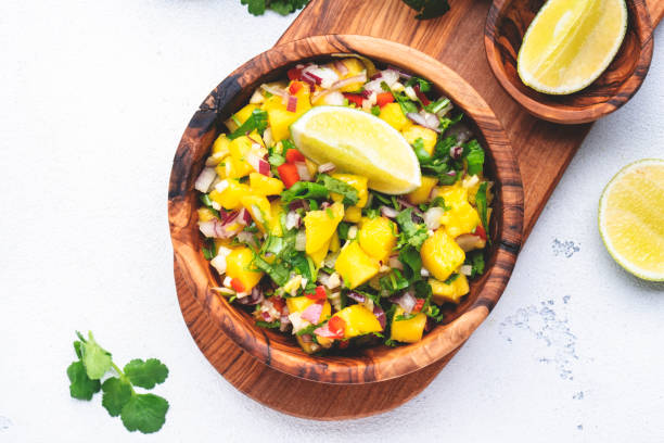 istock Spicy mango salsa sauce with red chili peppers, onion, garlic, lime and cilantro, white table background, top view 1463540144