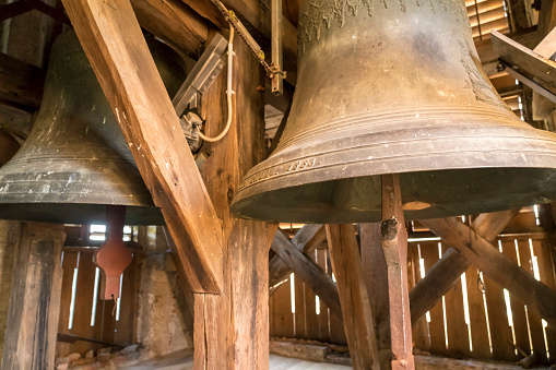 Very old, from the year 1853, two bronze bell in wooden construction in church tower