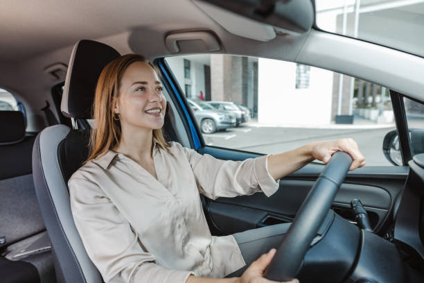 istock Young woman driving car and enjoying 1463544184