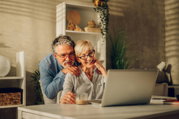 istock Senior couple using a laptop at home 1463545091