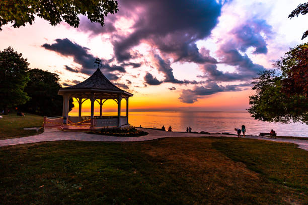 istock Lake Ontario Twilight - dramatic orange sky with black clouds. 1463545692