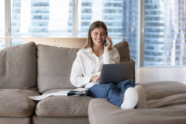istock Happy young freelancer girl answering mobile phone call 1463545914