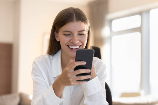 istock Cheerful mobile phone user woman talking on video call 1463545943