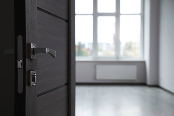 istock Wooden door open into empty office room, closeup. Space for text 1463546207