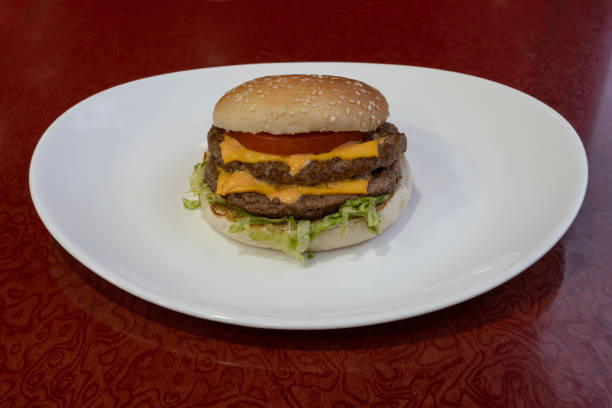 istock Paris, France - 01 24 2023: Middle East dishe culinary Still Life. Double Cheese burger with chopped steak, cheddar cheese, vegetable and salad 1463548956