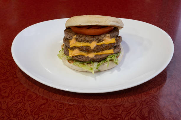 istock Paris, France - 01 24 2023: Middle East dishe culinary Still Life. Triple Cheese burger with chopped steak, cheddar cheese, vegetable and salad 1463548969