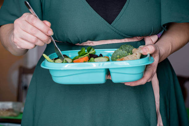 istock woman eating salad 1463550263