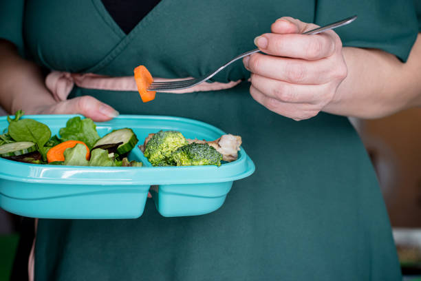 istock woman eating salad 1463550271