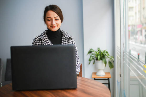 istock young woman working from laptop away from workplace 1463554399