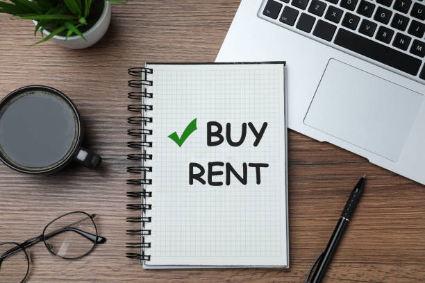 istock Buy or rent - choice concept. Flat lay composition with notebook on wooden table 1463555336