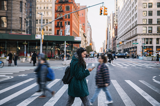 istock commuter checking apps on the streets of NYC 1463559891