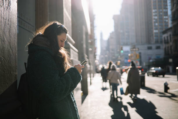 istock commuter checking apps on the streets of NYC 1463559947