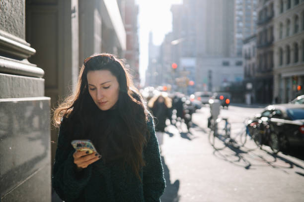 istock commuter checking apps on the streets of NYC 1463560013