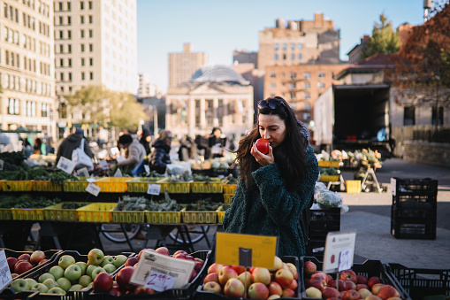 Woman going for grocery shopping in an open street market in New York, NYC.