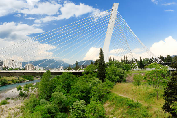 istock Aerial drone view of Millennium bridge and Moraca river in Podgorica, Montenegro. Cable stayed bridge with green area 1463565986