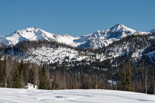 Snow Capped High Mountain Peaks are Backdrops to Wolf Creek Ski Area, Colorado. The San Juan Mountains receive generous amounts of snow, that provides great Winter recreation.