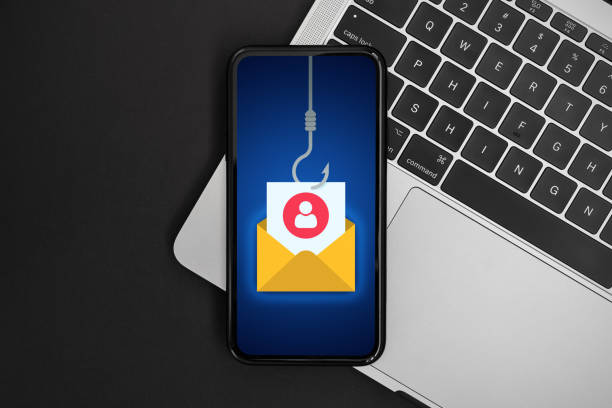istock Phishing bait alert concept on a mobile phone screen over a laptop 1463571143