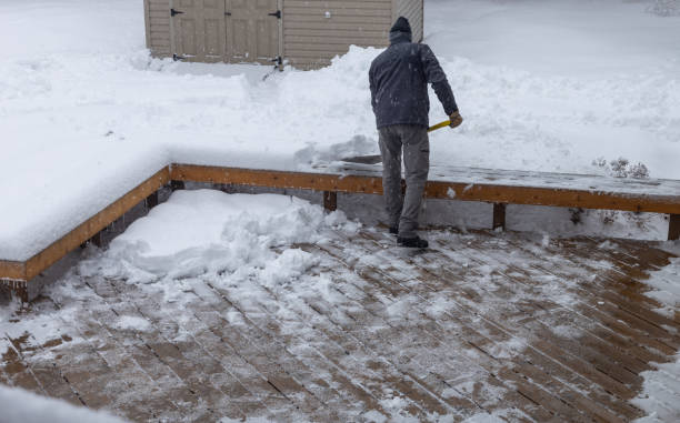 istock Man shoveling deep snow off a wooden deck 1463572051