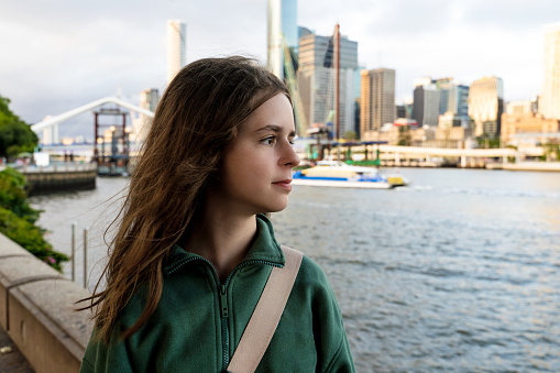 Teenage girl looking at Brisbane river