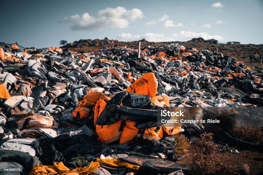 Life Jacket Cemetery in Lesvos, Greece Thousands of refugees arrived to the Greek Island of Lesvos by boat. Their lifejackets are a testimony of vast number of people that risked their lives trying to reach Europe Refugee Stock Photo
